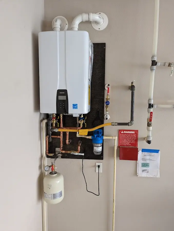 Professional plumber installing copper piping in a Enterprise home